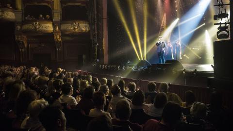 Audience sat watching Michael Ball performing on stage at the Alhambra Theatre