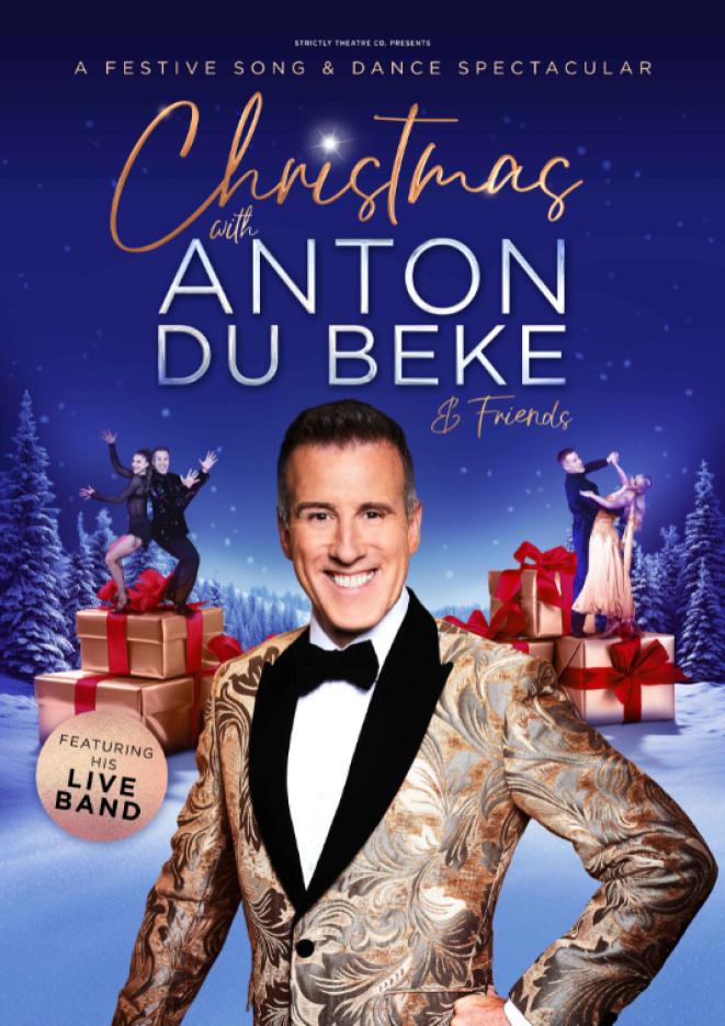 A blue background with snow at the bottom and stacked presents. Dancer Anton Du Beke stands in the centre looking to camera and wearing a smart jacket. 