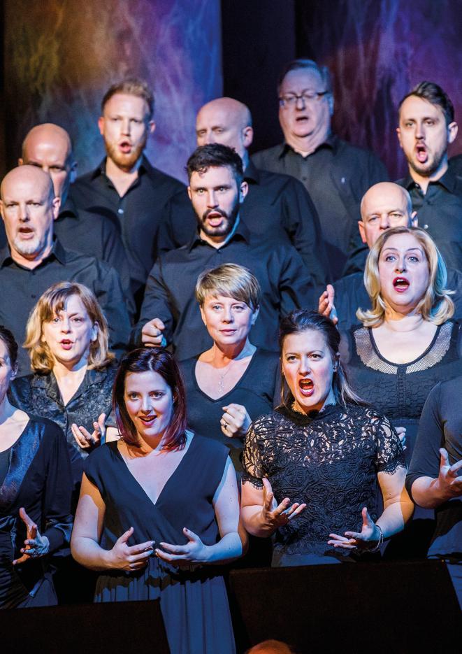 A group of opera singers wearing all black.