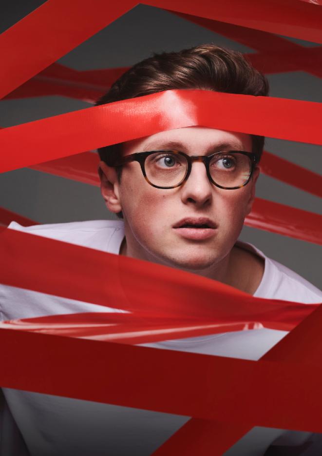 YouTube star Max Fosh surrounded by red tape.