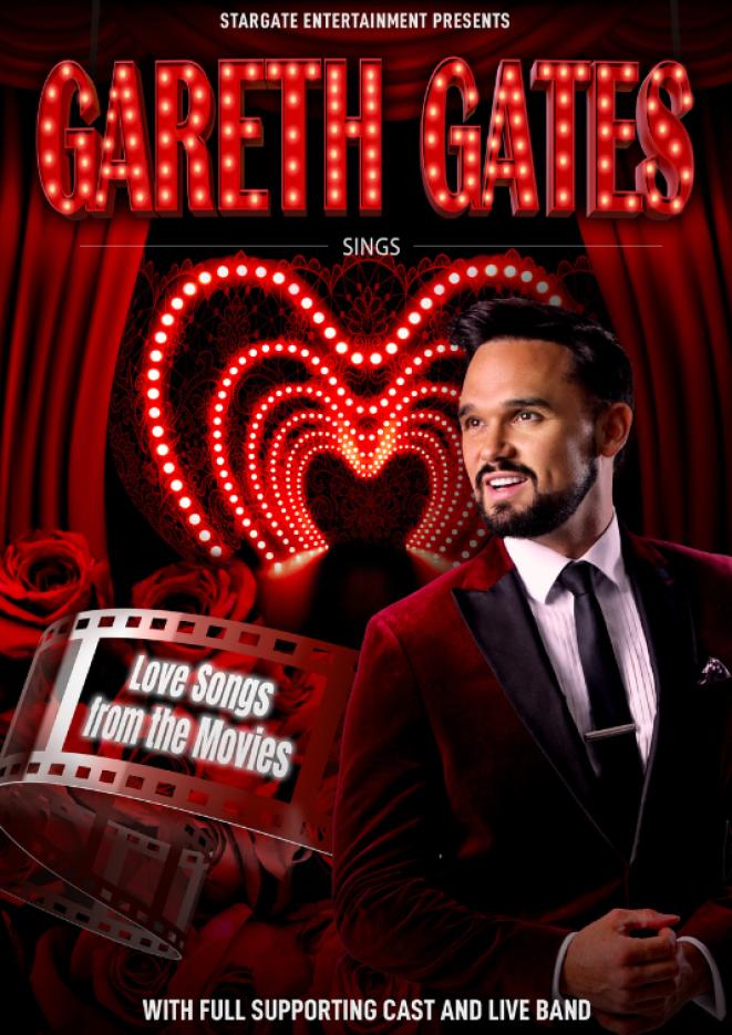 Singer Gareth Gates wears a black suit in front of heart shapes lights and text above that reads Gareth Gates.