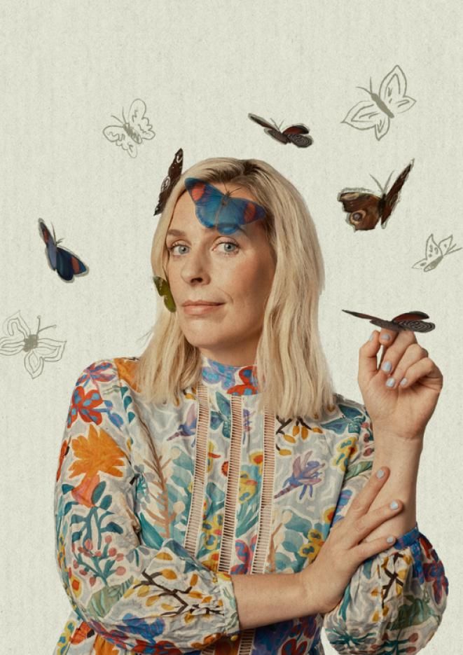 Comedian Sara Pascoe sits in front of a light background with graphics of butterflies around her head.