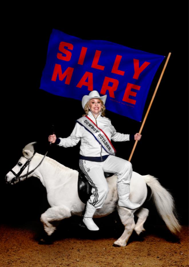 Comedian Hayley Ellis dressed in all white with a cowboy hat, sitting on a shetland pony.