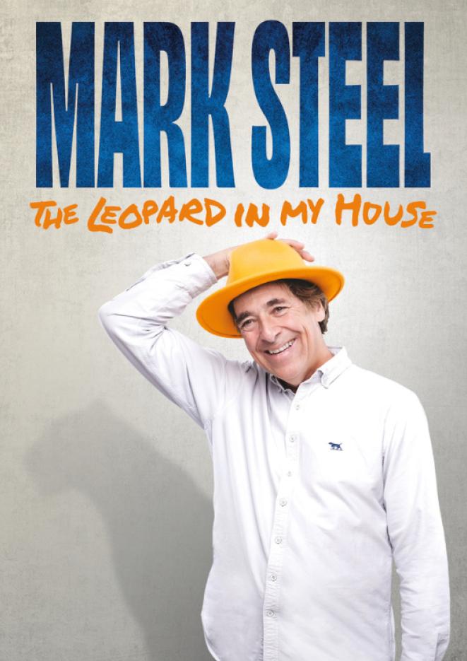 Comedian Mark Steel wears a white shirt and yellow had against a grey background. Text above reads Mark Steel The Leopard in my House.